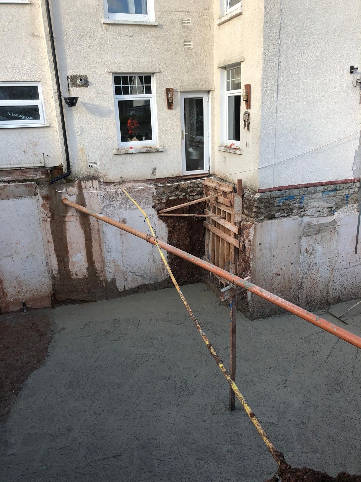 Foundation excavation with safety barriers for underpinning